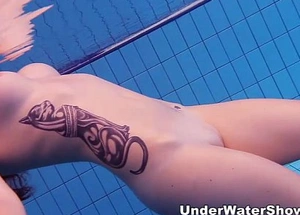 Redheaded cutie swimming nude relating to an obstacle come together